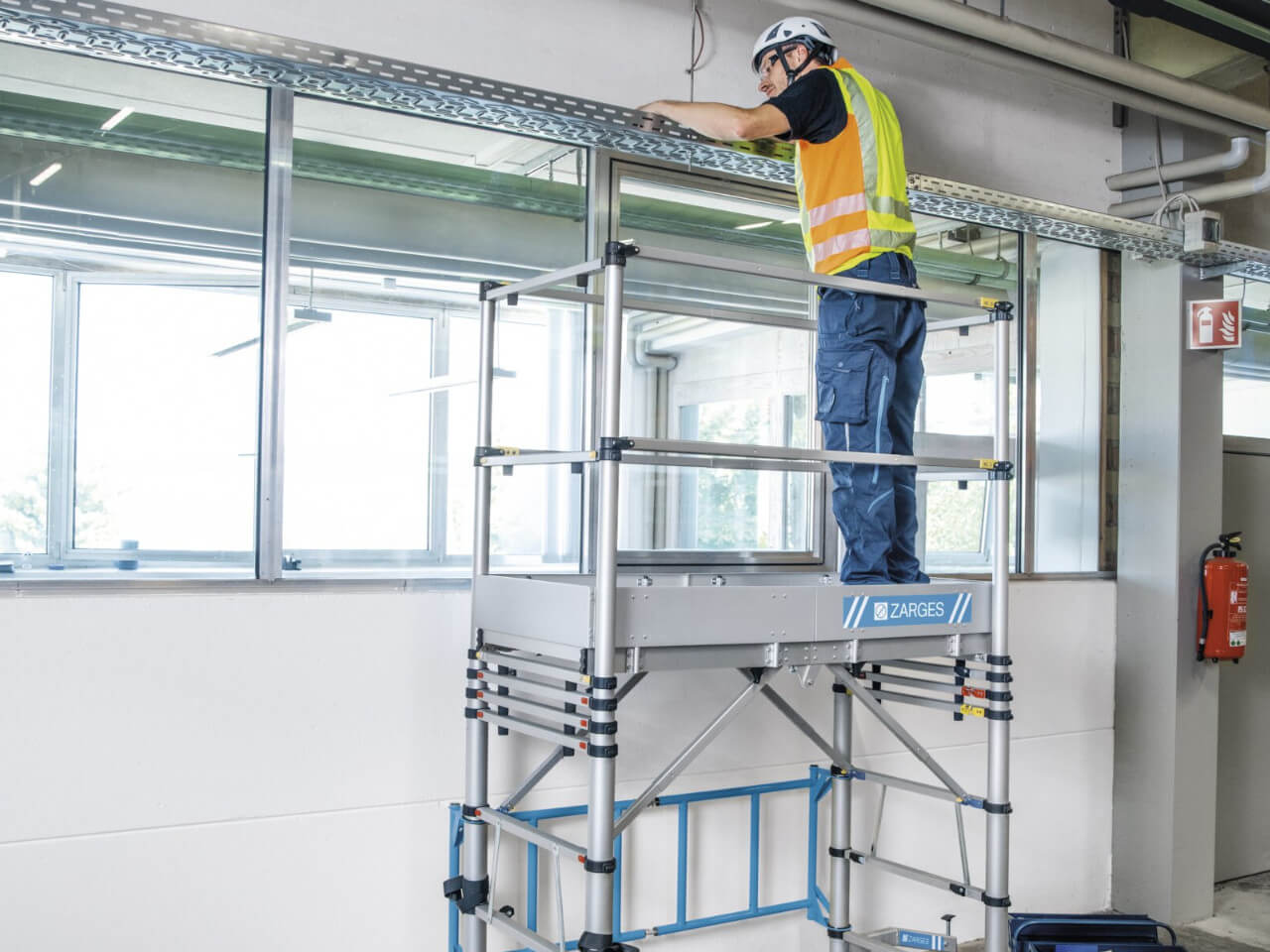 handwerker montiert leitung und kabel mithilfe vom zarges teletower 40387